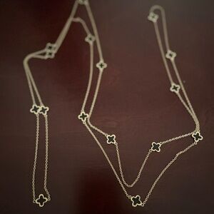 Long gold necklace with black decals